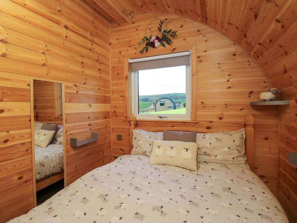 A bedroom with a bed and window at Cherry in Ulverston