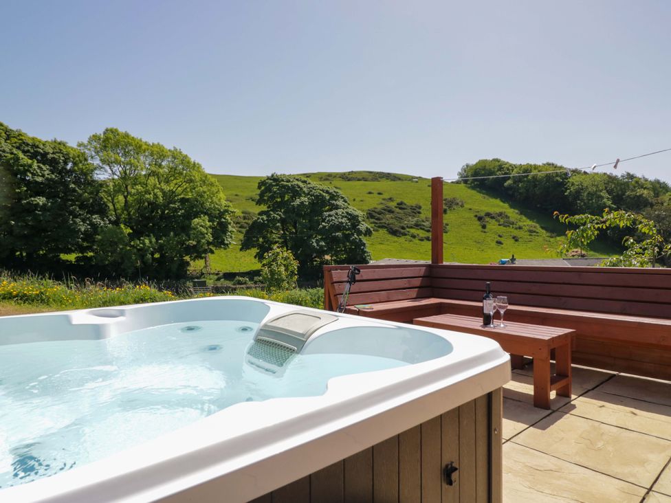 A hot tub and seating area with a view at Cherry in Ulverston