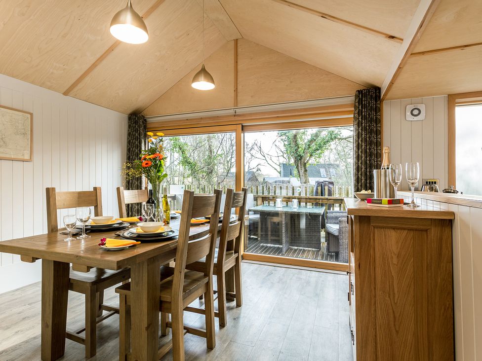 A dining room with a table and chairs at Lodge 14 in Corfe Castle