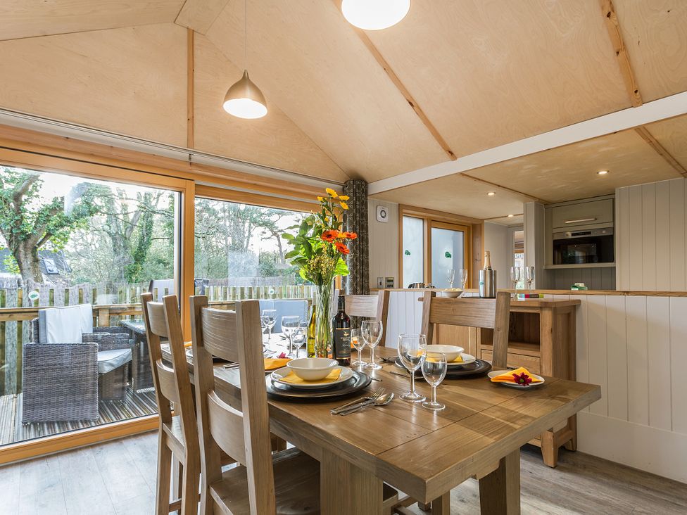 A dining room with a table set for dinner at Lodge 14 in Corfe Castle
