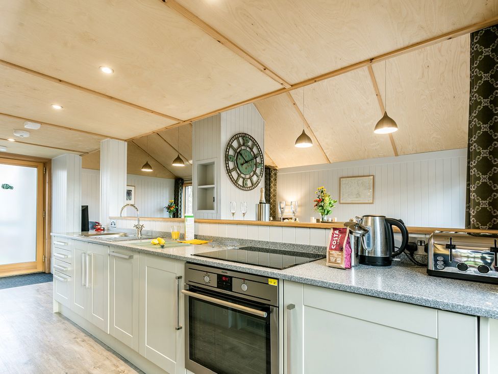 A kitchen with a sink and appliances at Lodge 14 in Corfe Castle