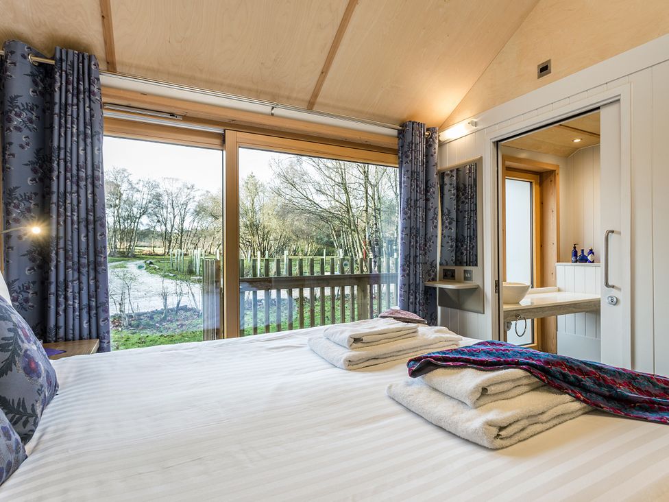 A bedroom with a bed and sink at Lodge 14 in Corfe Castle