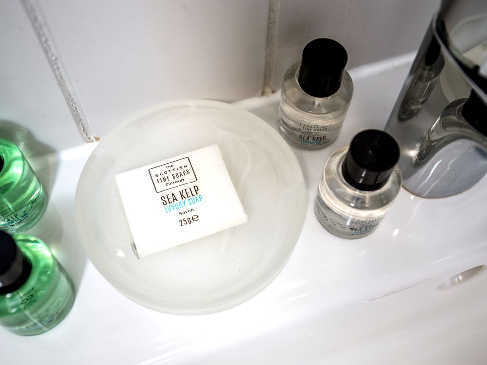 A collection of bathing products in a bathroom at Lodge 14 Corfe Castle