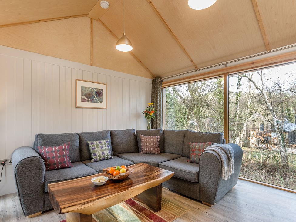 A living room with a sofa and coffee table at Lodge 15 in Corfe Castle