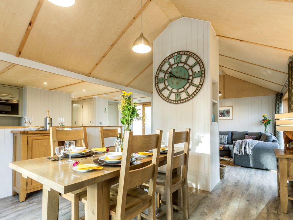 A dining area with a table and chairs at Lodge 15 in Corfe Castle