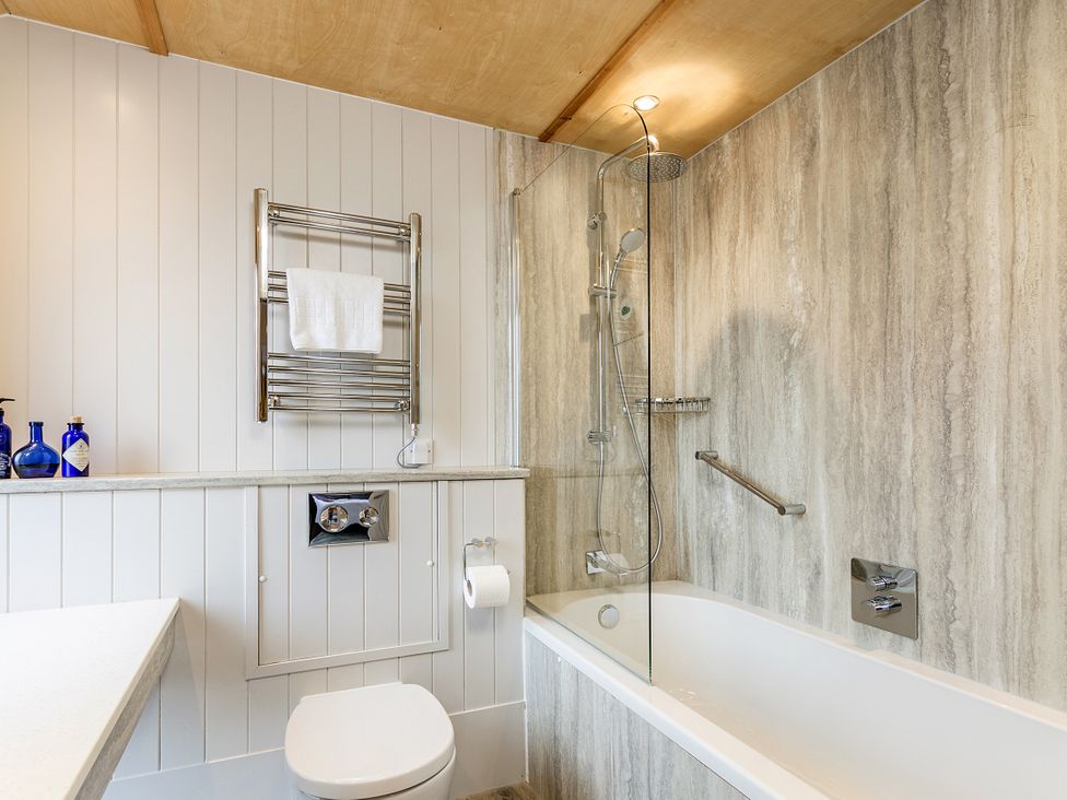 A bathroom with a bathtub and shower at Lodge 17 in Corfe Castle