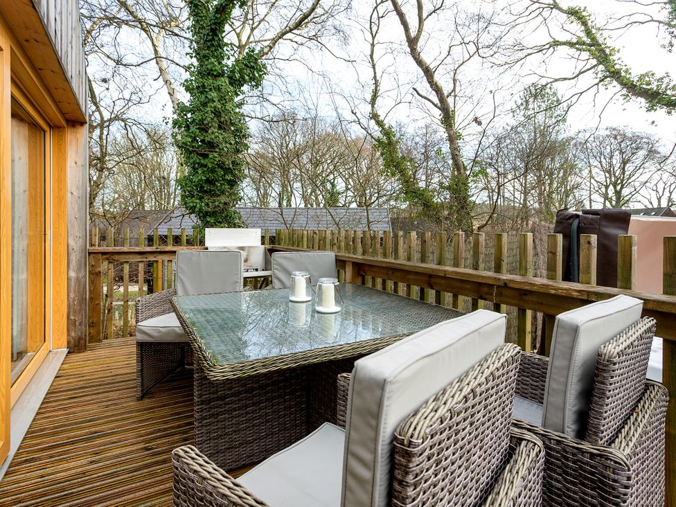 An outdoor patio with a table and chairs at Lodge 18 in Corfe Castle