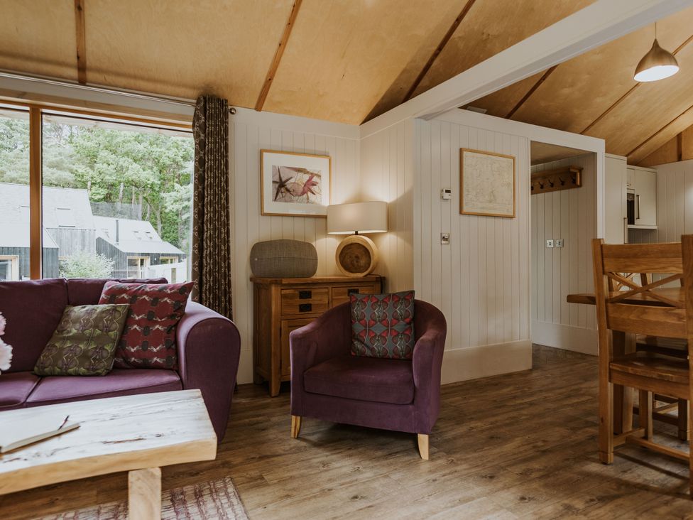 A living room with a sofa and armchair at Lodge 19 in Corfe Castle