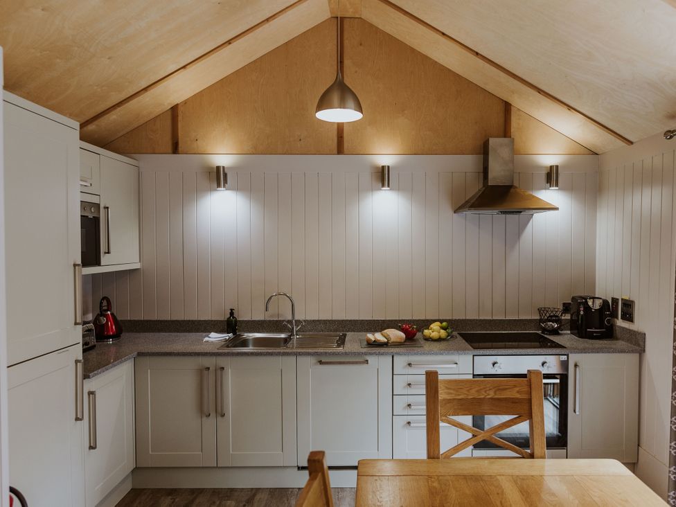 A kitchen with a sink and stove at Lodge 19 in Corfe Castle