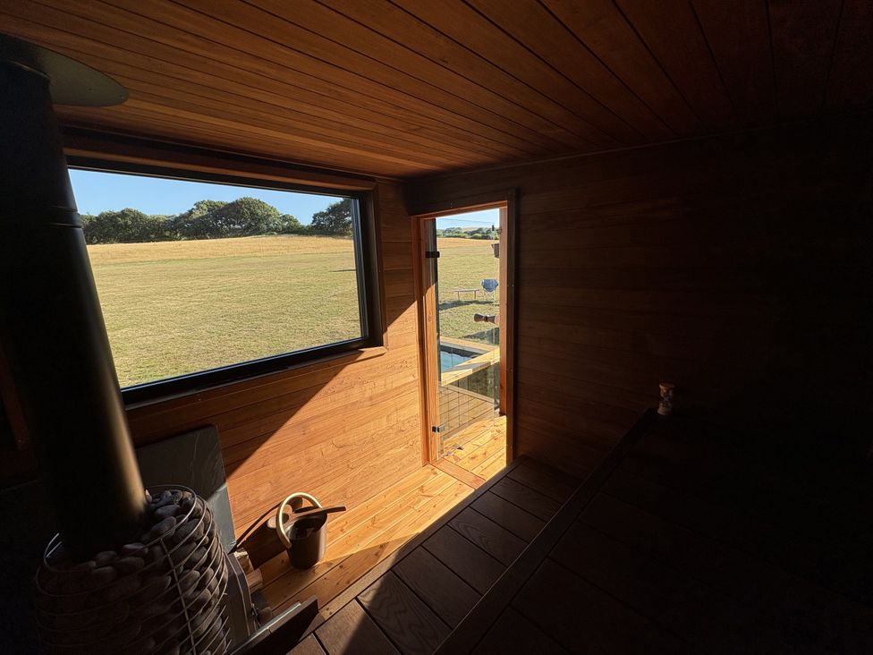 A room with wooden features and a door to the outside at Lodge 21 in Corfe Castle