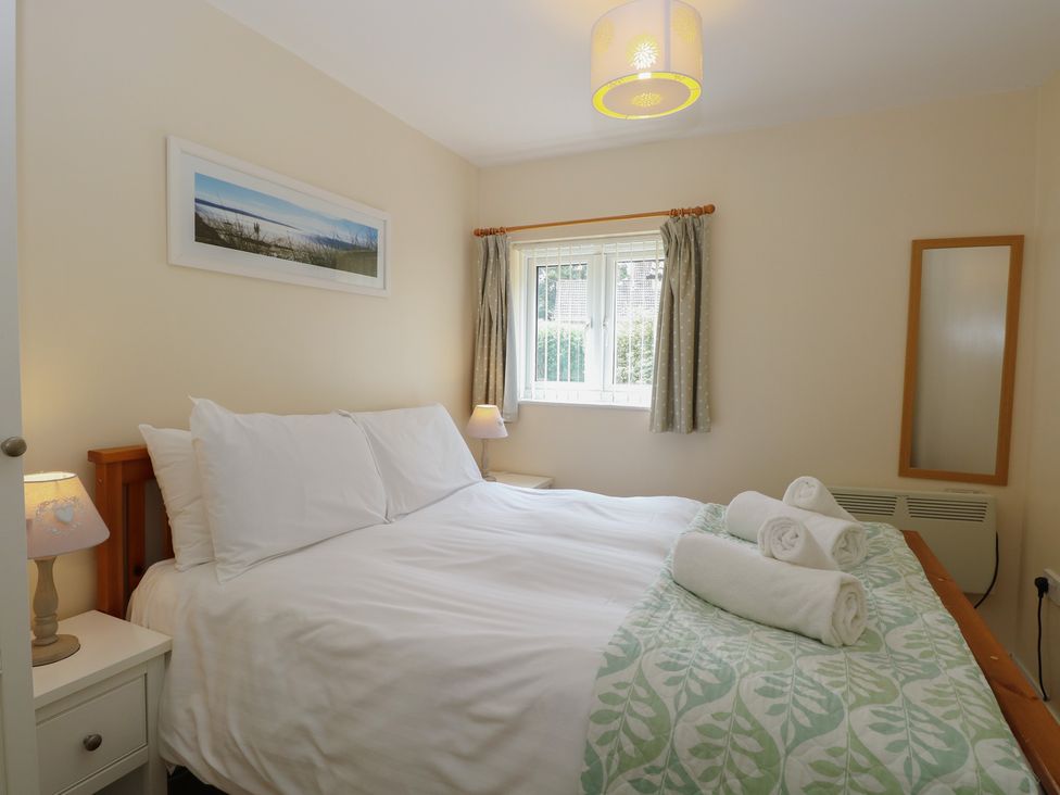 A bedroom with a bed and window at 14 The Dell Mundesley
