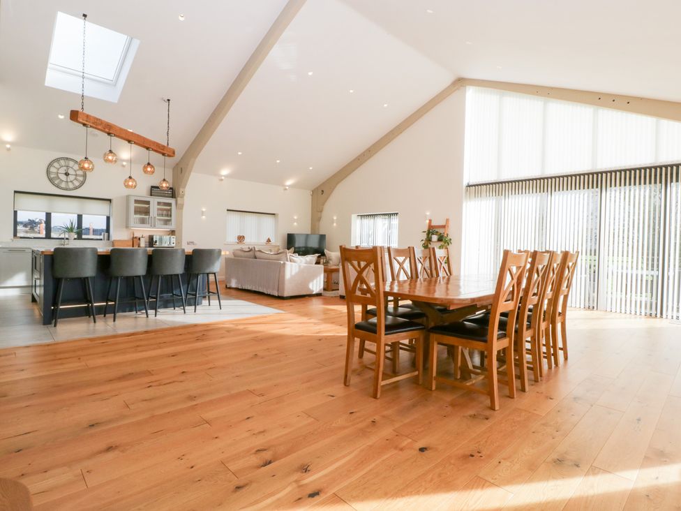A dining room with a large table and chairs at Bilsham Meadows in Aust
