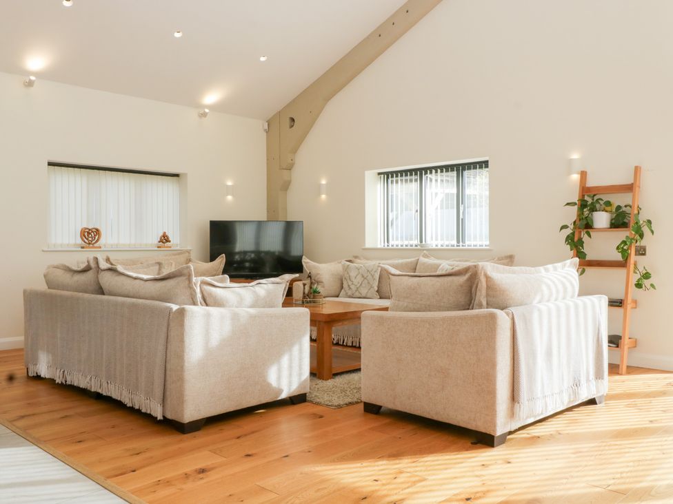 A living room with a sofa and television at Bilsham Meadows in Aust