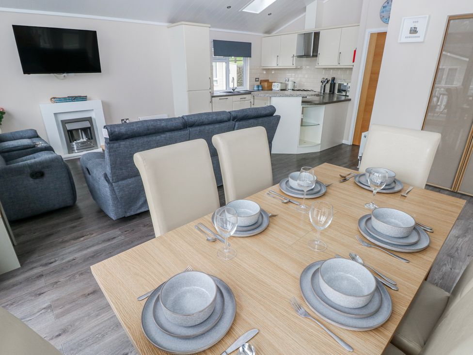 A dining room with a table set for dinner at Dono's Lodge, Stepaside near Kilgetty, Heritage Park