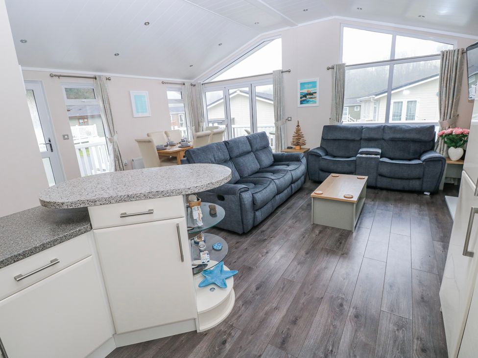 A living room with a sofa and coffee table at Dono's Lodge, Stepaside near Kilgetty, Heritage Park