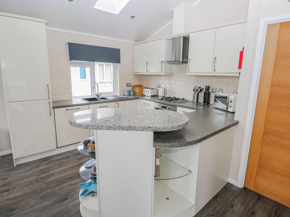 A kitchen with a countertop and appliances at Dono's Lodge, Stepaside near Kilgetty, Heritage Park