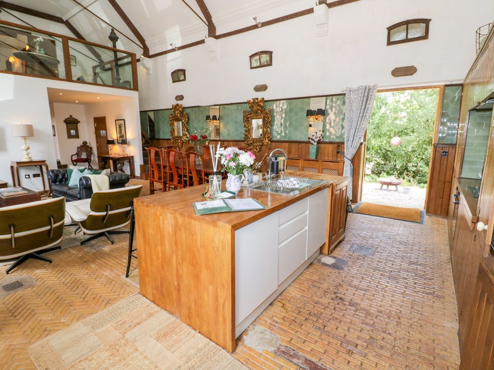 A kitchen with an island and dining table at Chetwynd Lodge Ingestre near Great Haywood