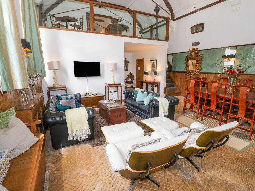 A living room with a sofa and dining area at Chetwynd Lodge Ingestre near Great Haywood