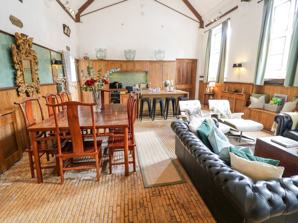 A living room with a dining table and kitchen area at Chetwynd Lodge Ingestre near Great Haywood