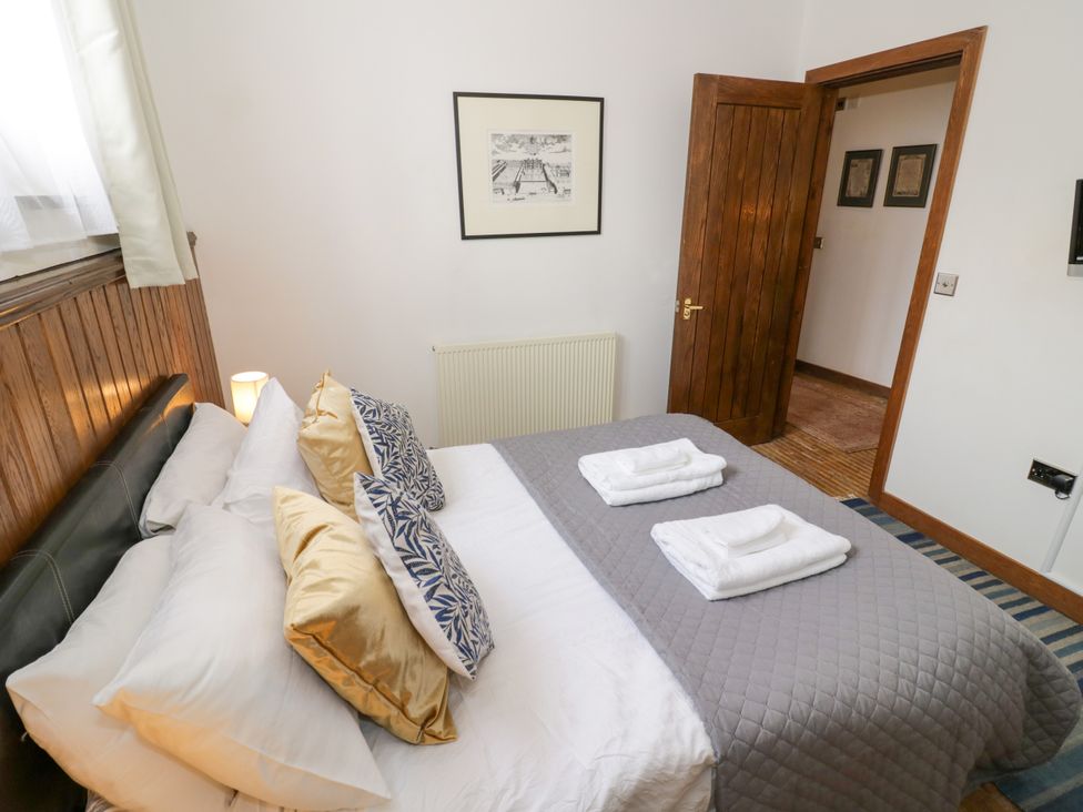 A bedroom with a bed and towels on top at Chetwynd Lodge Ingestre near Great Haywood