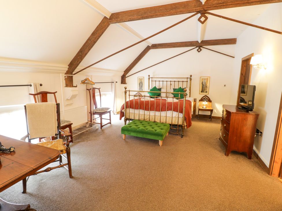 A bedroom with a bed and furniture at Chetwynd Lodge Ingestre near Great Haywood