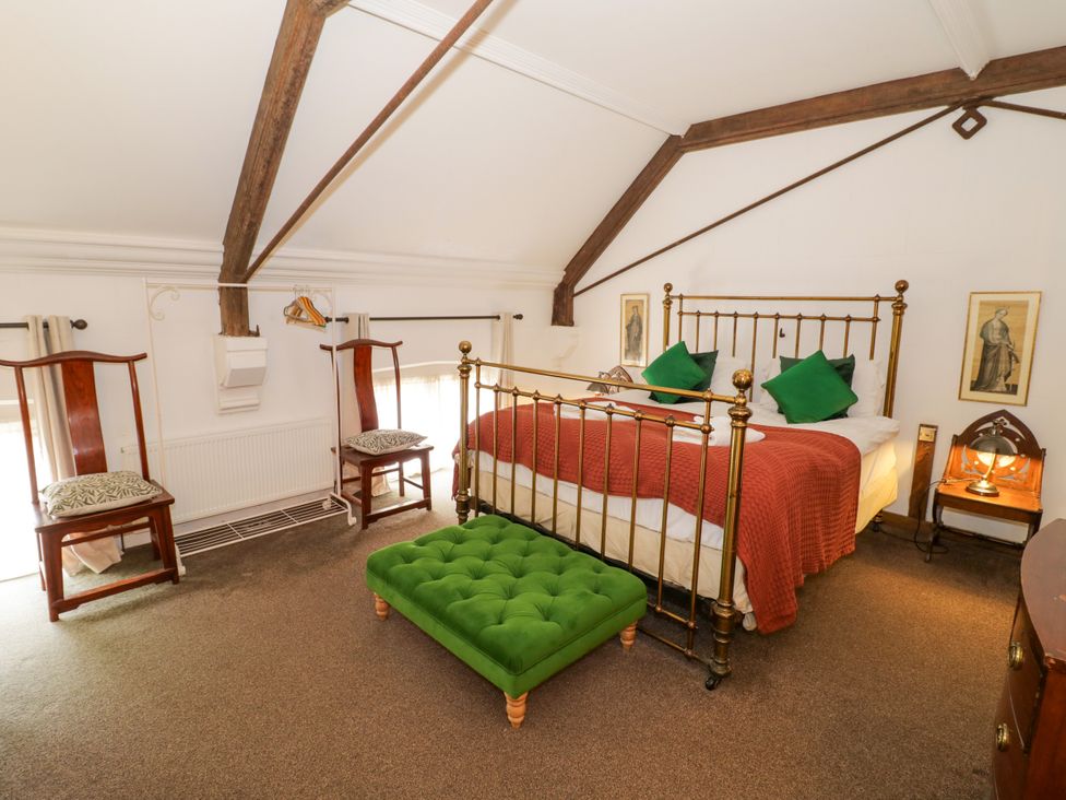 A bedroom with a bed and seating area at Chetwynd Lodge Ingestre near Great Haywood