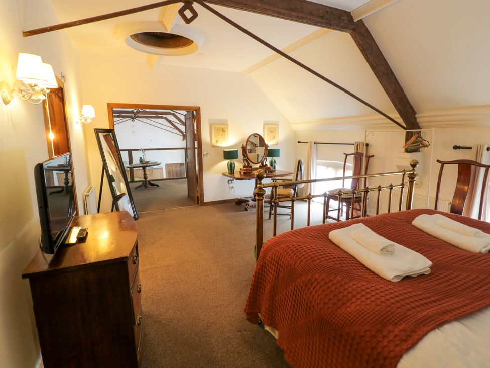 A bedroom with a bed and dresser at Chetwynd Lodge Ingestre near Great Haywood