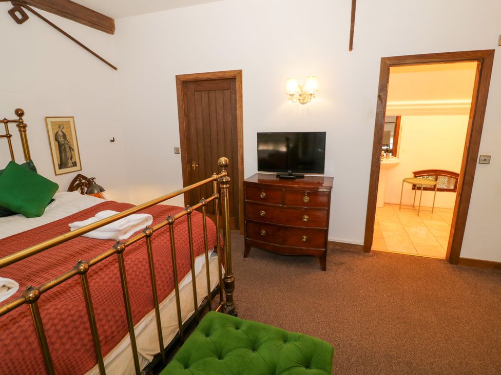 A bedroom with a bed, television, and access to a bathroom at Chetwynd Lodge Ingestre near Great Haywood