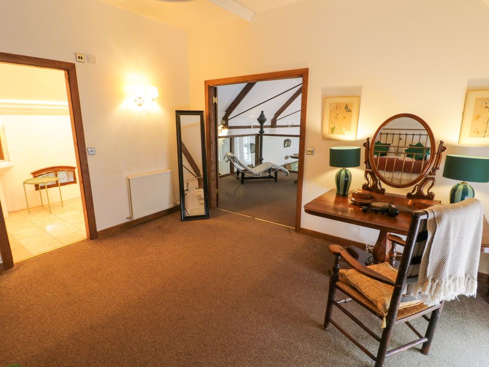 A bedroom with a table and chair at Chetwynd Lodge Ingestre near Great Haywood
