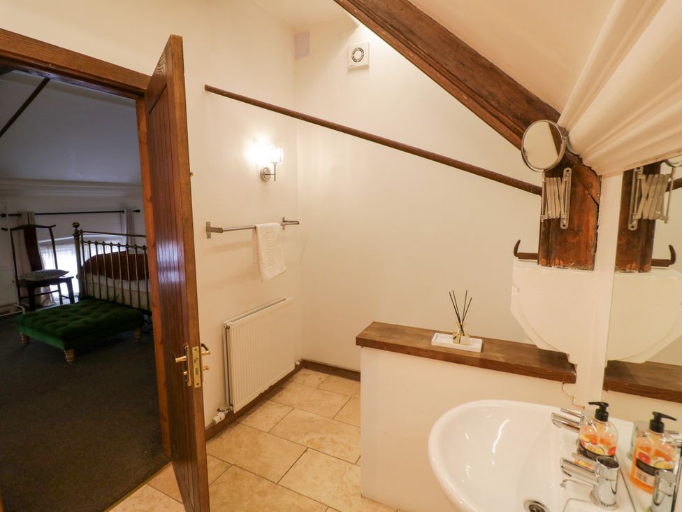 A bathroom with a sink and towel rack at Chetwynd Lodge Ingestre near Great Haywood