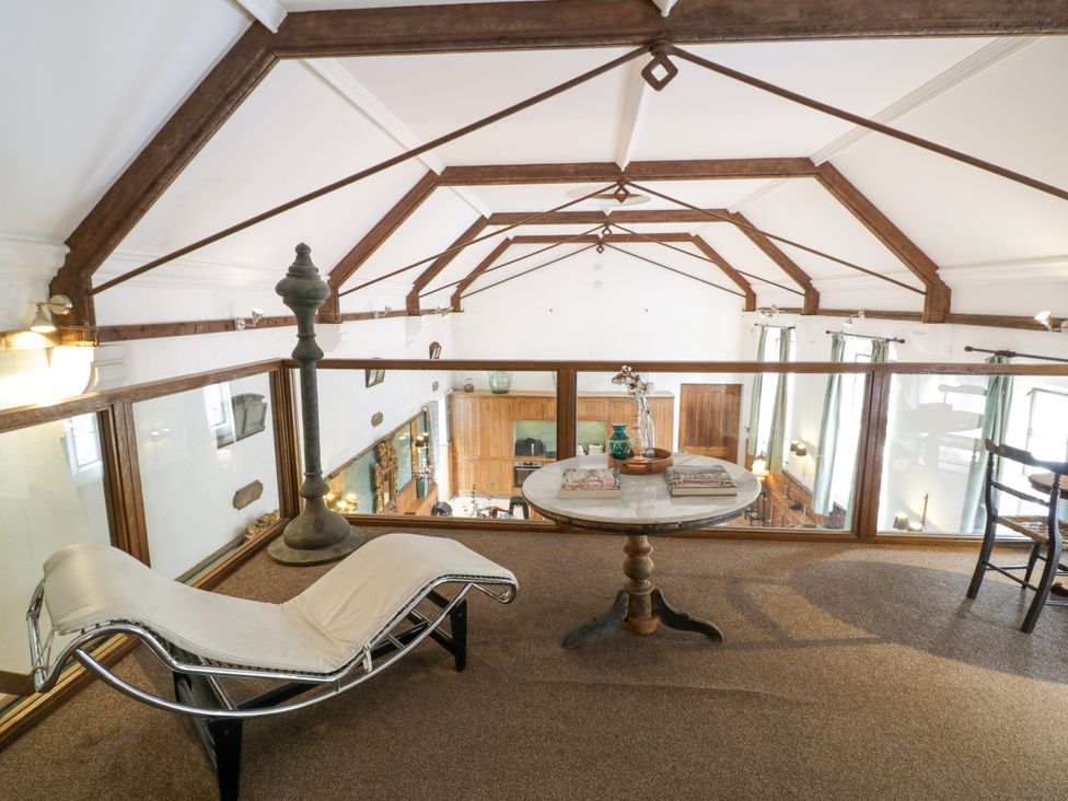 A loft with a chaise lounge and table at Chetwynd Lodge Ingestre near Great Haywood