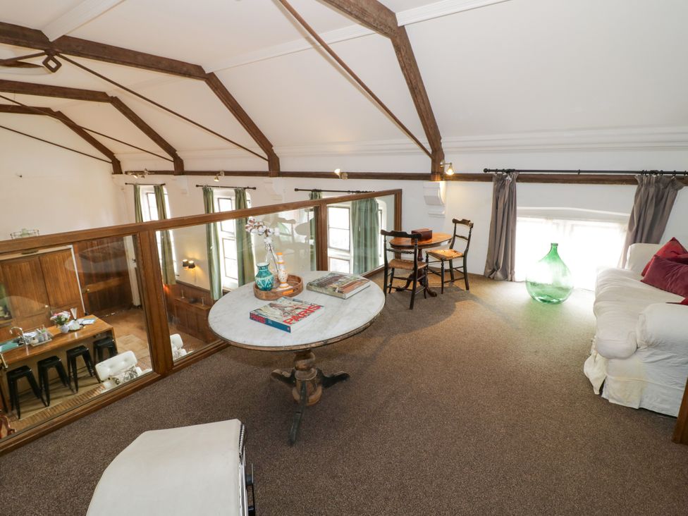 A loft with a table and chairs at Chetwynd Lodge Ingestre near Great Haywood