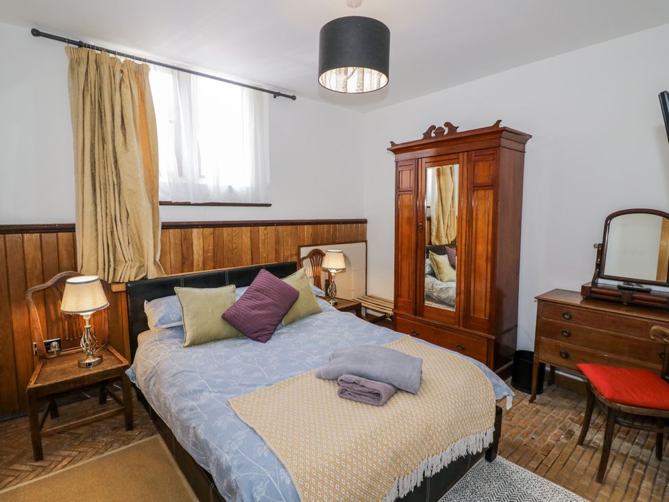 A bedroom with a bed and a wardrobe at Talbot Lodge Ingestre near Great Haywood