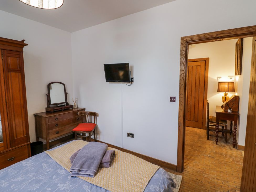 A bedroom with a bed, mirror, and television at Talbot Lodge Ingestre near Great Haywood