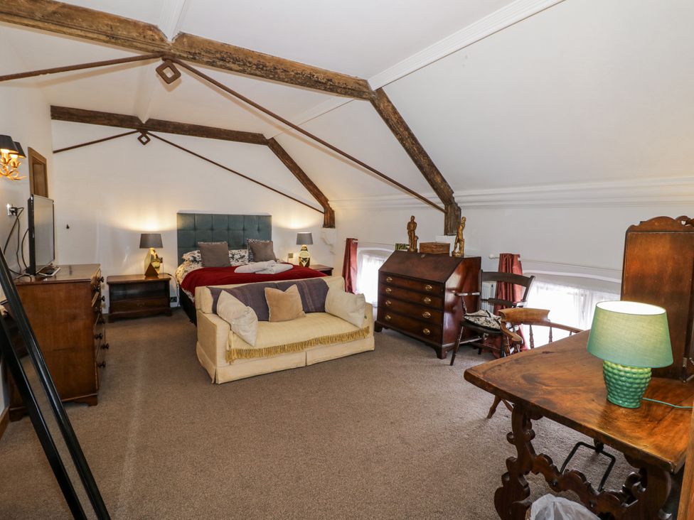 A bedroom with a bed and dresser at Talbot Lodge Ingestre near Great Haywood