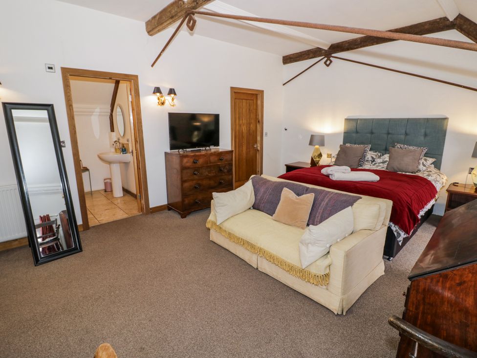 A bedroom with a bed and sofa at Talbot Lodge Ingestre near Great Haywood