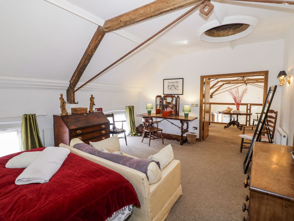 A bedroom with a bed and wooden furniture at Talbot Lodge Ingestre near Great Haywood