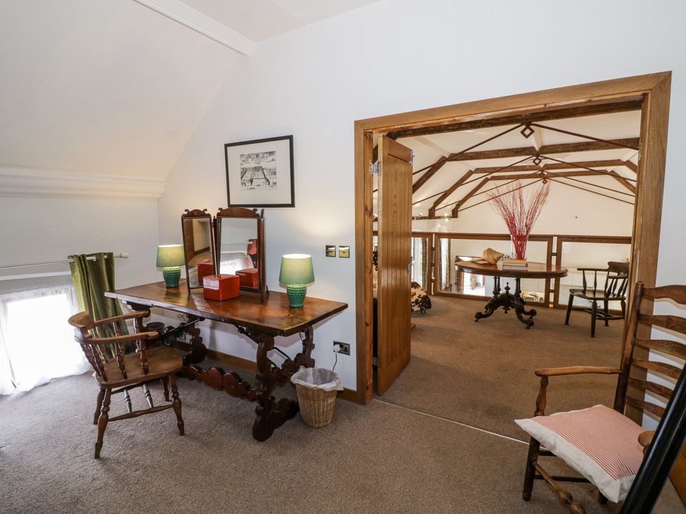 A loft with a table and chairs at Talbot Lodge Ingestre near Great Haywood