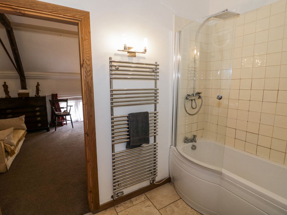 A bathroom with bathtub and towel rail at Talbot Lodge Ingestre near Great Haywood