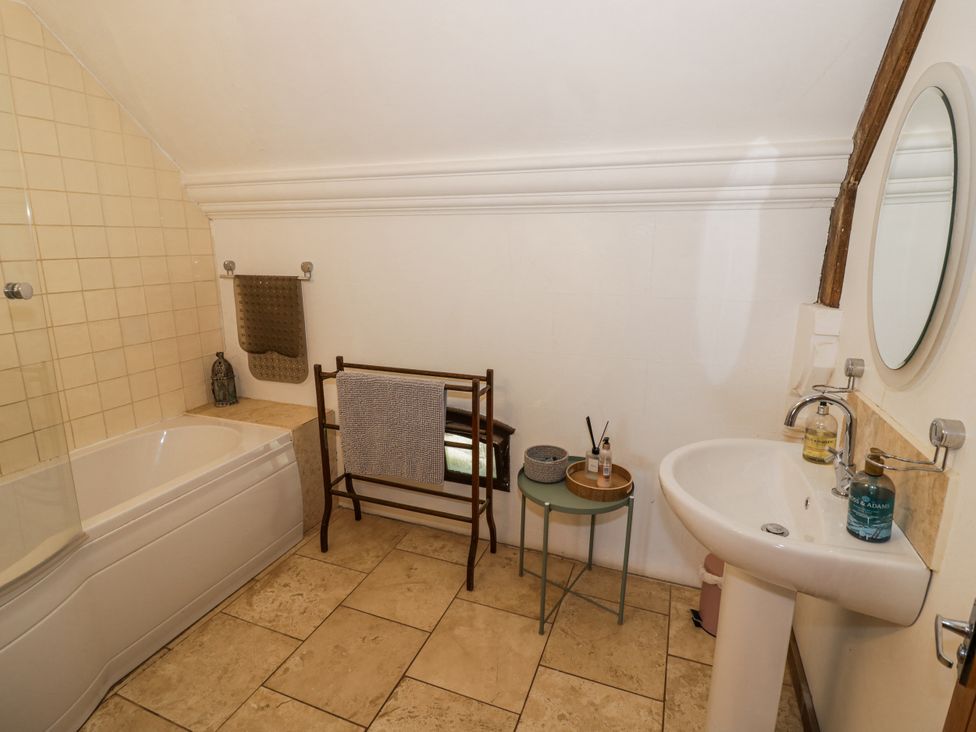 A bathroom with a bathtub and sink at Talbot Lodge Ingestre near Great Haywood