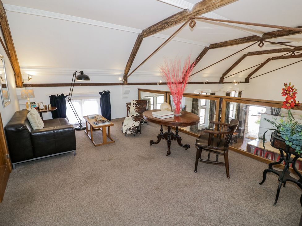 A living room with a sofa, table, and chairs at Talbot Lodge Ingestre near Great Haywood
