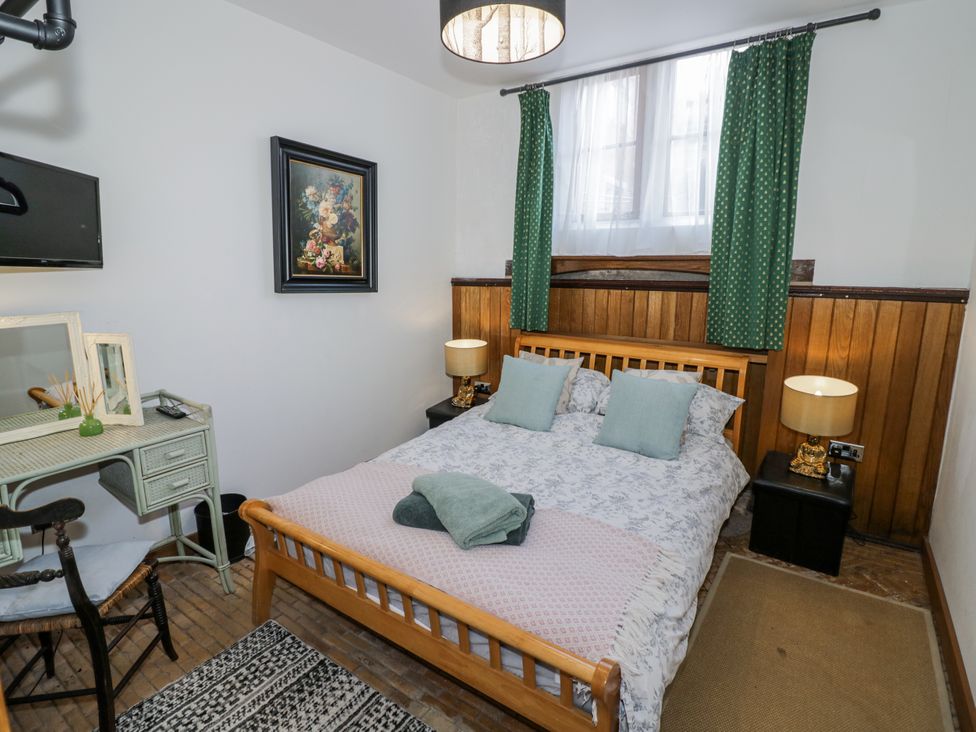 A bedroom with a bed and desk at Talbot Lodge Ingestre near Great Haywood