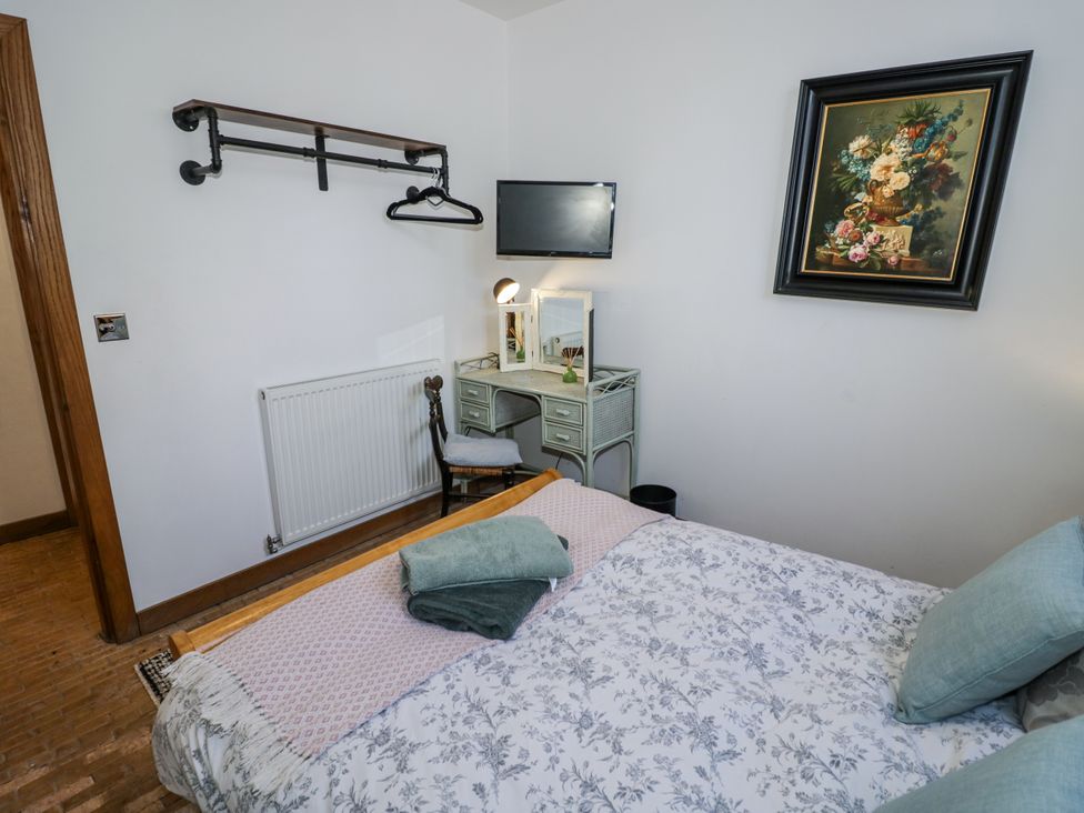 A bedroom with a bed and desk at Talbot Lodge Ingestre near Great Haywood