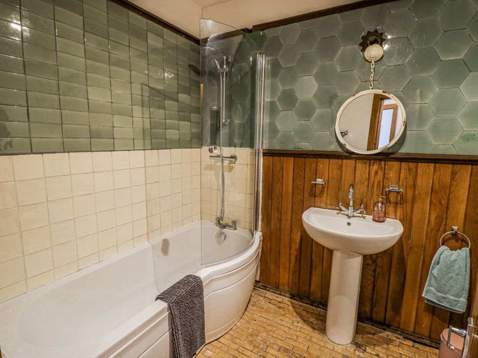 A bathroom with a bathtub and shower at Talbot Lodge Ingestre near Great Haywood