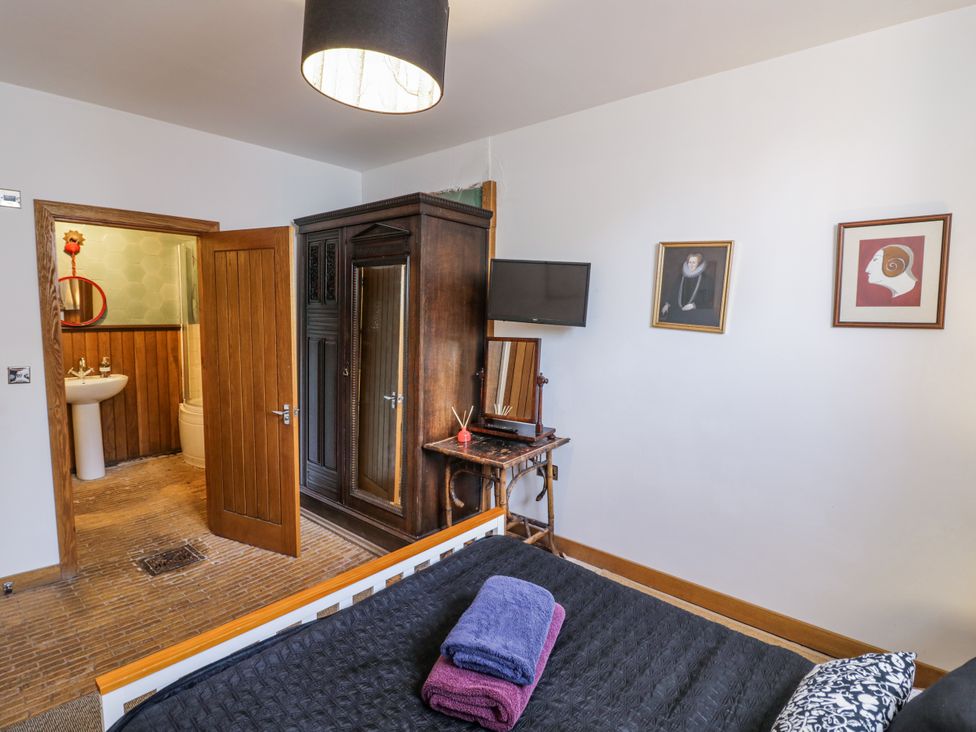 A bedroom with a wardrobe and a bathroom visible at Talbot Lodge Ingestre near Great Haywood