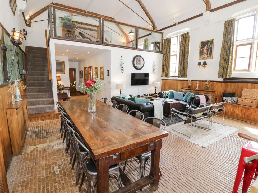 A living room with a dining table and sofa at Talbot Lodge Ingestre near Great Haywood