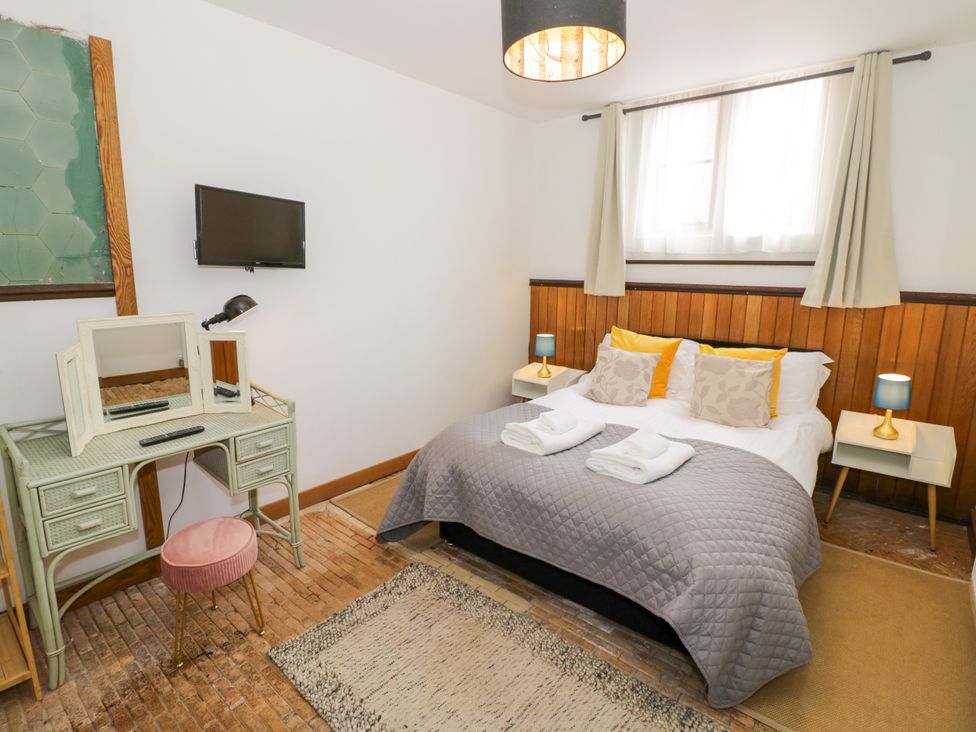 A bedroom with a bed and dressing table at Talbot Lodge Ingestre near Great Haywood