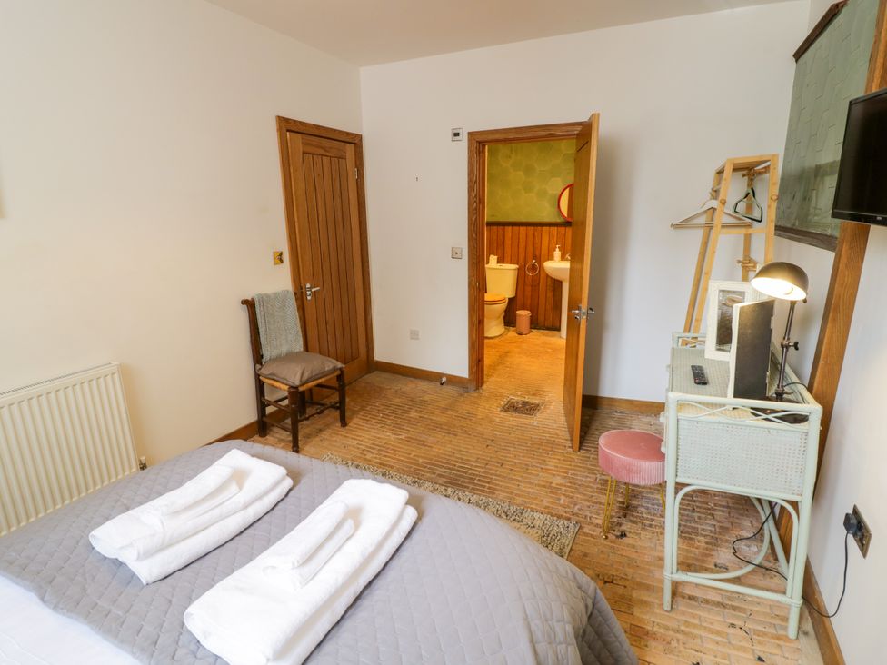 A bedroom with towels on the bed at Talbot Lodge Ingestre near Great Haywood