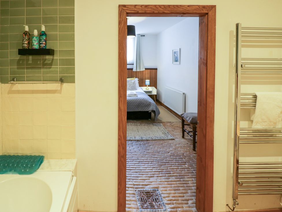A bathroom with a view of a bedroom at Talbot Lodge Ingestre near Great Haywood