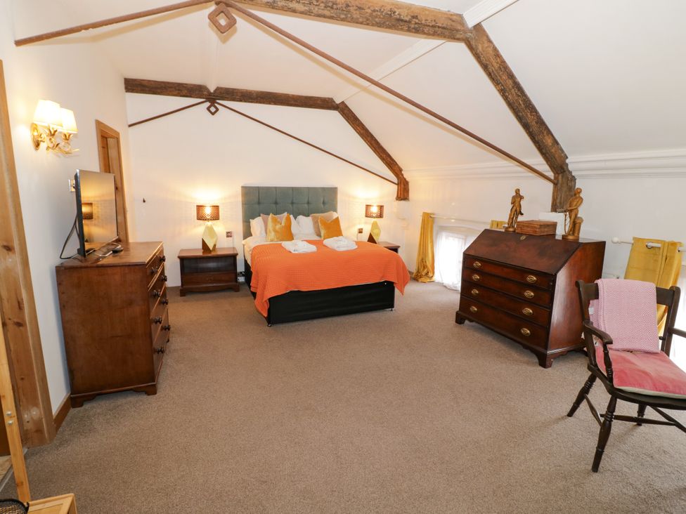 A bedroom with a bed and furniture at Talbot Lodge Ingestre near Great Haywood